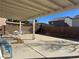 Spacious back patio offers ample room for entertaining, with a concrete surface and partial shade covering at 8901 Kingswood Dr, Las Vegas, NV 89147
