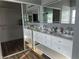 This bathroom boasts double sinks, a large mirror and vanity, and access to a walk-in closet for an organized and spacious feel at 8901 Kingswood Dr, Las Vegas, NV 89147