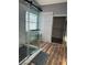 This modern bathroom features a walk-in glass shower with a black framed window, creating a sleek and stylish bathing space at 8901 Kingswood Dr, Las Vegas, NV 89147
