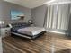 Comfortable bedroom with wood floors, a platform bed, and soft natural light at 8901 Kingswood Dr, Las Vegas, NV 89147