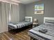 Comfortable bedroom featuring two twin beds with striped bedding, ideal for guests or children at 8901 Kingswood Dr, Las Vegas, NV 89147