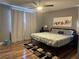 A comfortable bedroom with a ceiling fan, a cozy bed, an area rug, and natural light at 8901 Kingswood Dr, Las Vegas, NV 89147
