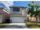 A two-story home featuring a pristine white garage door and complementary neutral color palette at 8901 Kingswood Dr, Las Vegas, NV 89147