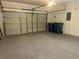 Spacious two-car garage with painted walls, large garage door, and epoxy flooring at 8901 Kingswood Dr, Las Vegas, NV 89147