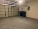 Spacious two-car garage with painted walls, large garage door, and epoxy flooring at 8901 Kingswood Dr, Las Vegas, NV 89147