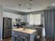 Bright kitchen featuring stainless steel appliances, white cabinetry, and a stylish marble island at 8901 Kingswood Dr, Las Vegas, NV 89147