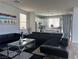 Open-concept living room and kitchen with stainless steel appliances and modern finishes at 8901 Kingswood Dr, Las Vegas, NV 89147
