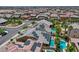 Aerial view of neighborhood homes with solar panels, backyards, and a distant city skyline at 9015 Chopper Prairie St, Las Vegas, NV 89131