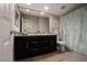 Bathroom featuring a double vanity with granite countertops, framed mirror, and shower with curtain at 9015 Chopper Prairie St, Las Vegas, NV 89131