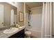 Bright bathroom showcasing a vanity with a dark cabinet and tub-shower combo at 9015 Chopper Prairie St, Las Vegas, NV 89131