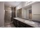 Modern bathroom with dual sinks, granite countertops, and a glass-enclosed shower at 9015 Chopper Prairie St, Las Vegas, NV 89131