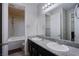 Bathroom featuring double sinks, dark cabinetry, and a separate tub and shower area at 9015 Chopper Prairie St, Las Vegas, NV 89131