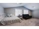 Bright bedroom with white shutters, a comfortable bed, and a cozy loveseat at 9015 Chopper Prairie St, Las Vegas, NV 89131