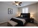 Neutral bedroom with a dark bed frame, two side tables, and a sitting bench at 9015 Chopper Prairie St, Las Vegas, NV 89131