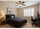 Modern bedroom featuring a cozy bed, dark desk, and plantation shutters at 9015 Chopper Prairie St, Las Vegas, NV 89131