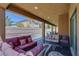 Inviting covered patio featuring ample seating, a fire pit, and pool views at 9015 Chopper Prairie St, Las Vegas, NV 89131