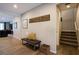 Inviting hallway features wood floors, bench seating, and access to the home's staircase at 9015 Chopper Prairie St, Las Vegas, NV 89131