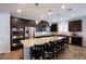 Spacious kitchen with a large island, stainless steel appliances, and dark wood cabinetry at 9015 Chopper Prairie St, Las Vegas, NV 89131