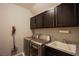 Functional laundry room with washer, dryer, sink, and plenty of cabinet storage at 9015 Chopper Prairie St, Las Vegas, NV 89131