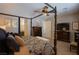 Spacious main bedroom with a four poster bed, decorative artwork, and a ceiling fan at 9015 Chopper Prairie St, Las Vegas, NV 89131