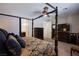 Cozy main bedroom with a four-poster bed, dresser, and ceiling fan at 9015 Chopper Prairie St, Las Vegas, NV 89131