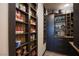 Well-stocked pantry with custom shelving and cabinetry, offering ample storage space for groceries at 9015 Chopper Prairie St, Las Vegas, NV 89131