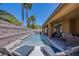 Private backyard oasis featuring a modern pool, water feature and covered patio at 9015 Chopper Prairie St, Las Vegas, NV 89131