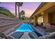 Inviting backyard pool with sun loungers and a covered patio, perfect for relaxing and entertaining guests at 9015 Chopper Prairie St, Las Vegas, NV 89131