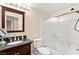 Cozy bathroom with framed mirror, granite countertop, and sliding glass shower doors at 9733 Northern Dancer Dr, Las Vegas, NV 89117
