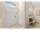 Welcoming foyer with a front door, neutral walls, tile floors and decorative window at 9733 Northern Dancer Dr, Las Vegas, NV 89117