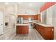 Bright eat-in kitchen with a center island and wood cabinets, complemented by light-colored flooring at 9733 Northern Dancer Dr, Las Vegas, NV 89117