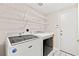 Efficient laundry room with tile flooring and shelving at 9733 Northern Dancer Dr, Las Vegas, NV 89117