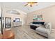 Open-concept living room featuring neutral walls, ceiling fan, and lots of natural light at 9733 Northern Dancer Dr, Las Vegas, NV 89117