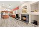 Inviting living area with a fireplace and an open layout connected to the kitchen, offering a seamless flow at 9733 Northern Dancer Dr, Las Vegas, NV 89117