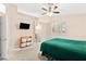 This main bedroom has carpet, a ceiling fan, a TV, and bathroom access at 9733 Northern Dancer Dr, Las Vegas, NV 89117