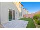 Private backyard featuring an artificial lawn and a stone-paved patio at 10347 Restless River St, Las Vegas, NV 89141