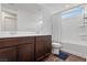 Bathroom featuring a double sink vanity and tiled shower/tub at 10347 Restless River St, Las Vegas, NV 89141