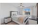 Bright bedroom with a ceiling fan and a large window at 10347 Restless River St, Las Vegas, NV 89141