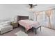 Cozy bedroom featuring a plush chair, bench, and a ceiling fan at 10347 Restless River St, Las Vegas, NV 89141