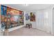 Bright bedroom featuring a large wall poster and neutral carpeting at 10347 Restless River St, Las Vegas, NV 89141