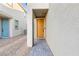 Inviting entryway features a yellow front door and stone pathway at 10347 Restless River St, Las Vegas, NV 89141