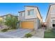 Modern two-story home features a two-car garage and contemporary landscaping at 10347 Restless River St, Las Vegas, NV 89141
