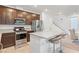 Modern kitchen with stainless steel appliances, granite countertops, and a breakfast bar at 10347 Restless River St, Las Vegas, NV 89141