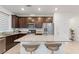Modern kitchen featuring granite countertops, stainless steel appliances, and dark wood cabinets at 10347 Restless River St, Las Vegas, NV 89141