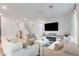 Bright living room features plush seating, modern entertainment center with fireplace, and staircase at 10347 Restless River St, Las Vegas, NV 89141