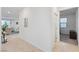 Inviting hallway with access to a living room featuring elegant seating and natural light at 10347 Restless River St, Las Vegas, NV 89141
