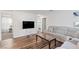 Living room featuring hard wood floors and an entertainment area with couch at 10347 Restless River St, Las Vegas, NV 89141