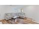 Upstairs Gathering room with wood-look flooring and a comfortable sectional sofa at 10347 Restless River St, Las Vegas, NV 89141