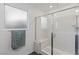 Glass-enclosed shower with seat features sleek fixtures and bright lighting at 10347 Restless River St, Las Vegas, NV 89141