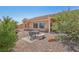 Backyard view highlighting landscaping, covered patio, and outdoor seating area at 10428 Villa Ridge Dr, Las Vegas, NV 89134